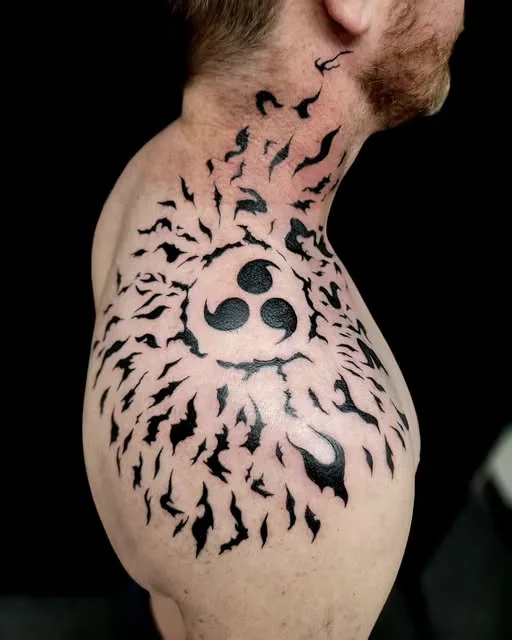 Sharingan-style shoulder tattoo