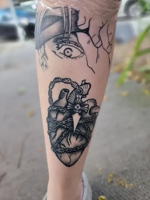 Chained anatomical heart tattoo